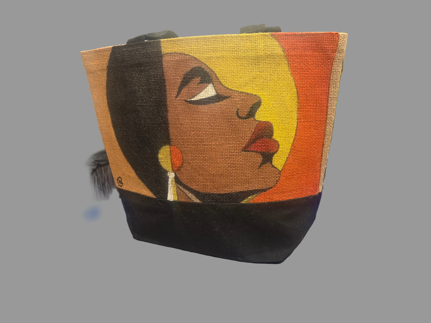 Tote bag with artistic design of a woman's face. 