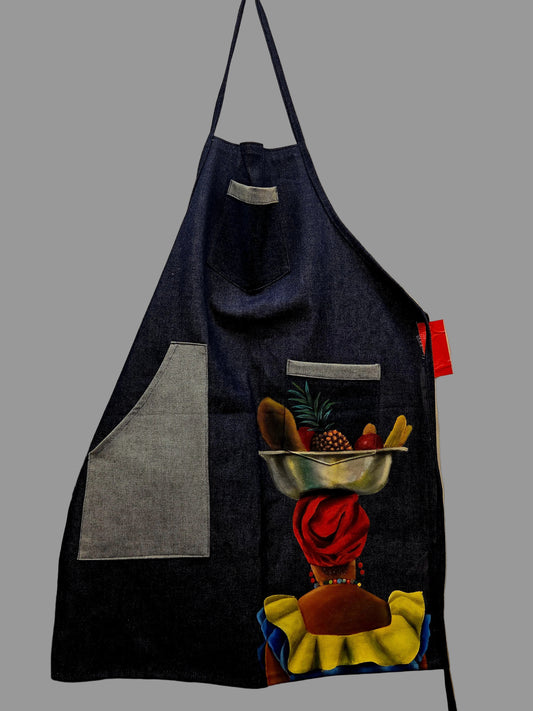Denim apron with colorful designs hanging on a wall